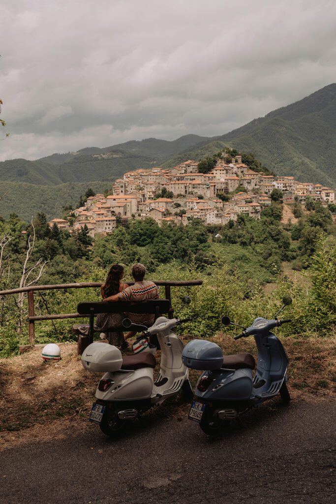 a couple admiring a beautiful view on a Tuscan village